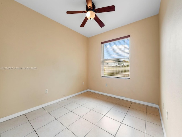 empty room featuring light tile patterned floors, baseboards, and ceiling fan