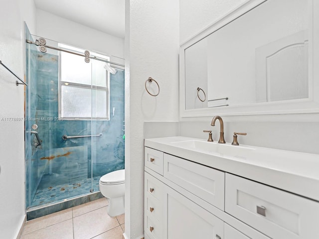 full bathroom with toilet, a shower stall, tile patterned flooring, and vanity