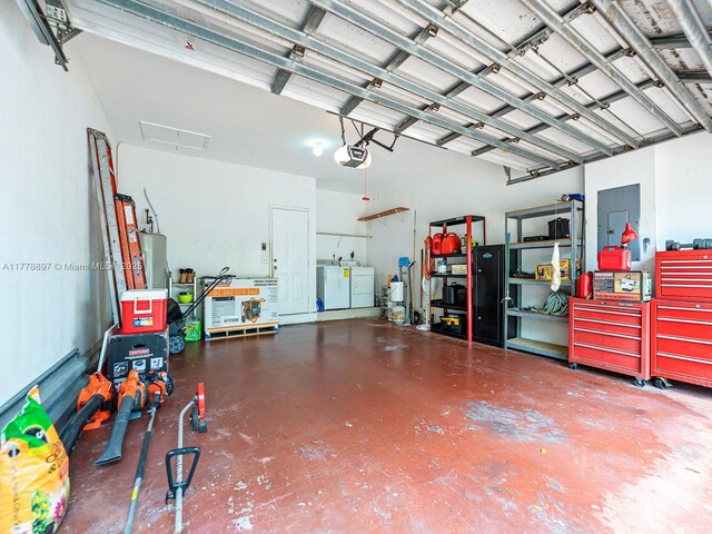 garage with washing machine and dryer and a garage door opener