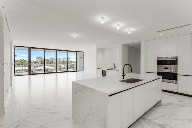 160 Isle Of Venice Dr Unit Ph2, Fort Lauderdale, FL 33301 - kitchen featuring wine cooler, marble finish floor, a sink, and modern cabinets
