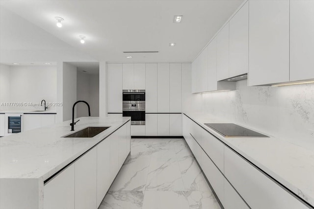 160 Isle Of Venice Dr Unit Ph2, Fort Lauderdale, FL 33301 - kitchen featuring modern cabinets, white cabinetry, a sink, black electric stovetop, and stainless steel double oven