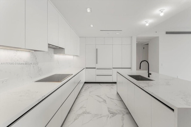 160 Isle Of Venice Dr Unit Ph2, Fort Lauderdale, FL 33301 - kitchen with white cabinets, modern cabinets, a sink, black electric stovetop, and marble finish floor