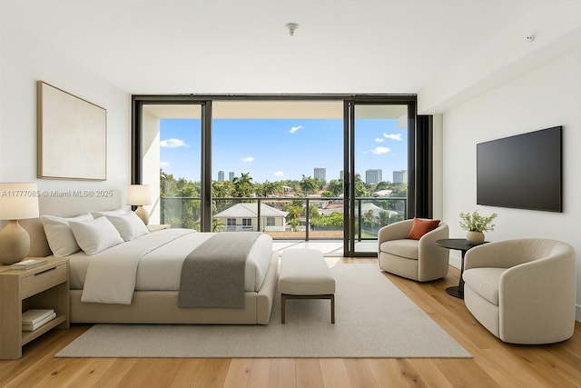 160 Isle Of Venice Dr Unit Ph2, Fort Lauderdale, FL 33301 - bedroom with light wood finished floors, multiple windows, access to outside, and floor to ceiling windows
