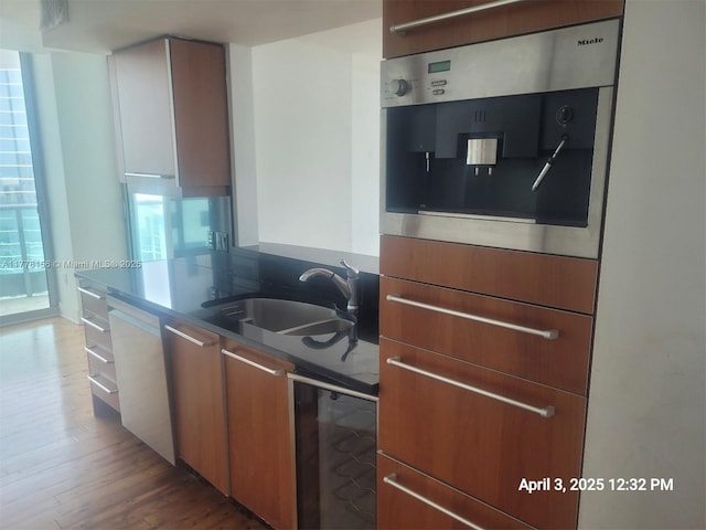 1331 Brickell Bay Dr Unit 2702, Miami, FL 33131 - kitchen with a sink, dishwashing machine, wood finished floors, oven, and modern cabinets