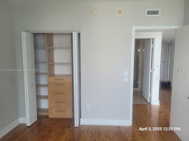 1331 Brickell Bay Dr Unit 2702, Miami, FL 33131 - unfurnished bedroom featuring wood finished floors, baseboards, and a closet