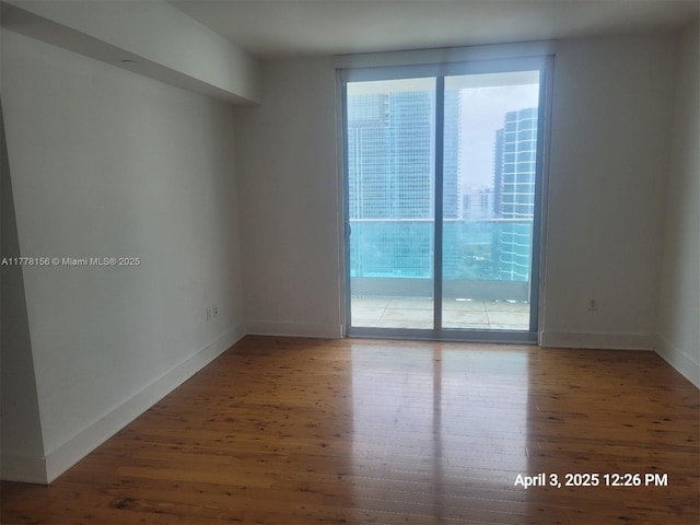 1331 Brickell Bay Dr Unit 2702, Miami, FL 33131 - empty room featuring wood-type flooring and baseboards