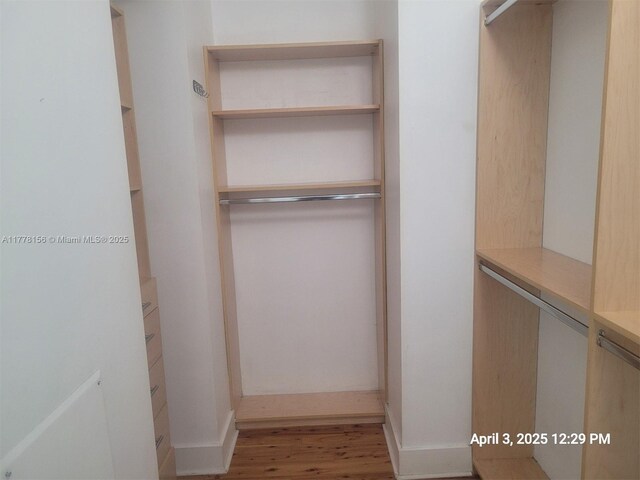1331 Brickell Bay Dr Unit 2702, Miami, FL 33131 - walk in closet featuring wood finished floors