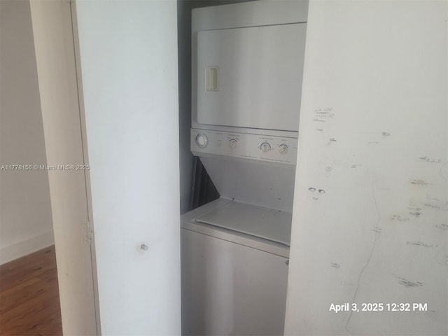 1331 Brickell Bay Dr Unit 2702, Miami, FL 33131 - washroom featuring stacked washer / dryer and wood finished floors
