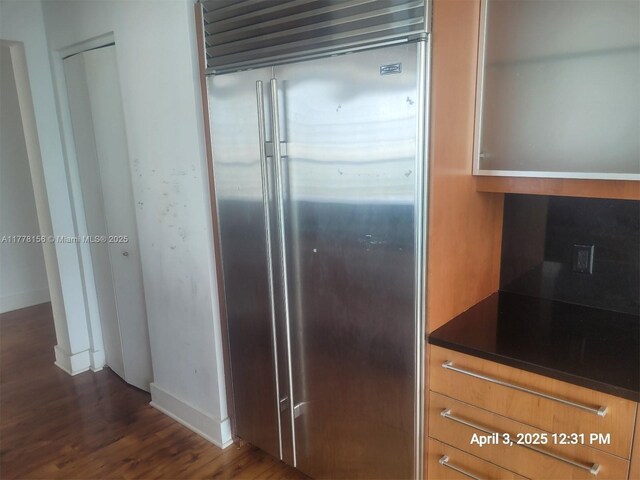 1331 Brickell Bay Dr Unit 2702, Miami, FL 33131 - kitchen with stainless steel built in refrigerator, dark wood-style floors, dark countertops, and baseboards