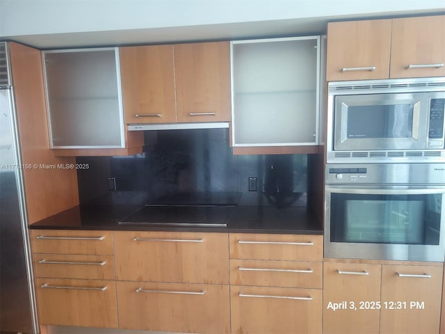 1331 Brickell Bay Dr Unit 2702, Miami, FL 33131 - kitchen with appliances with stainless steel finishes, ventilation hood, backsplash, and modern cabinets