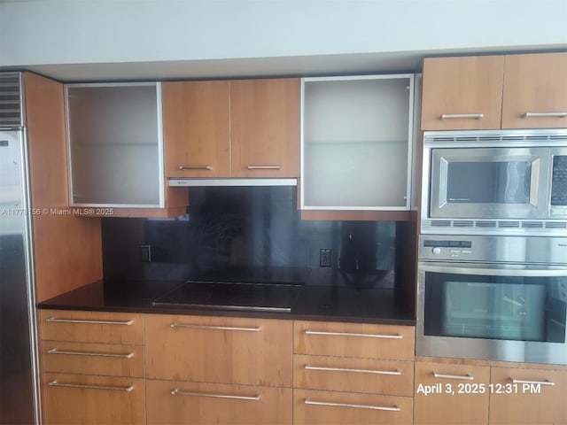 1331 Brickell Bay Dr Unit 2702, Miami, FL 33131 - kitchen featuring stainless steel appliances, ventilation hood, modern cabinets, and decorative backsplash