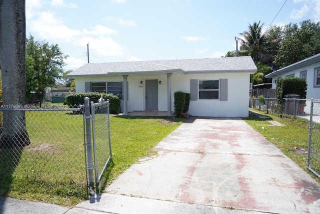 view of front of property with a front yard, fence, driveway, and stucco siding