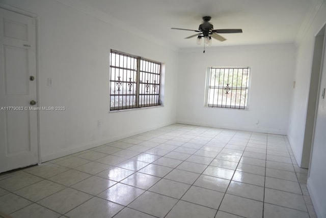 unfurnished room featuring ornamental molding, ceiling fan, light tile patterned floors, and baseboards