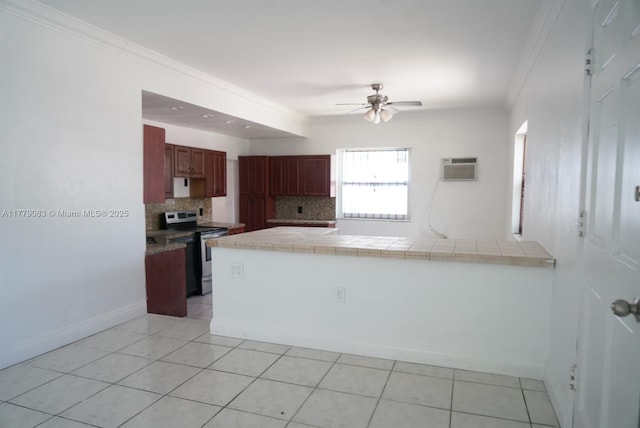 kitchen with a wall mounted air conditioner, electric range, backsplash, crown molding, and tile countertops