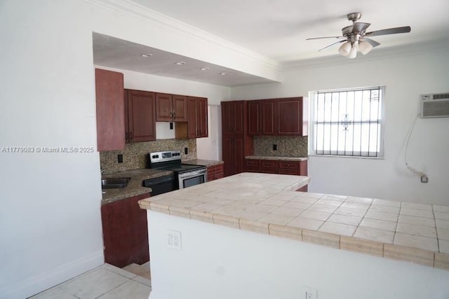 kitchen with decorative backsplash, crown molding, stainless steel electric range oven, and a ceiling fan
