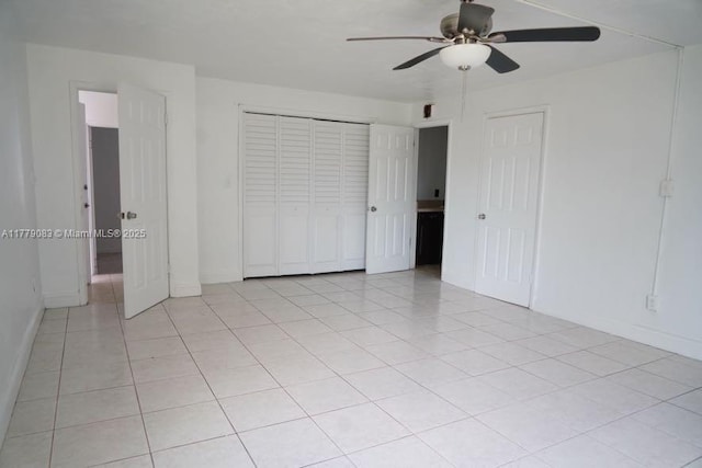 unfurnished bedroom with baseboards, a ceiling fan, and light tile patterned flooring