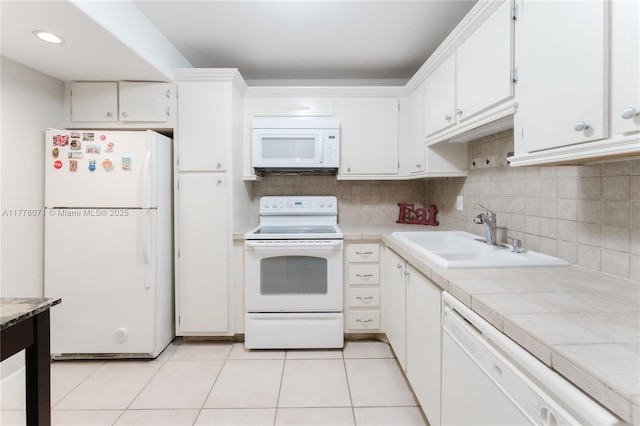 1811 Jefferson St Unit 304, Hollywood, FL 33020 - kitchen featuring white appliances, tile countertops, white cabinets, light tile patterned floors, and tasteful backsplash