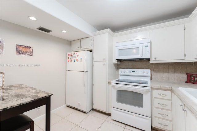 1811 Jefferson St Unit 304, Hollywood, FL 33020 - kitchen featuring white appliances, white cabinets, tile counters, backsplash, and recessed lighting