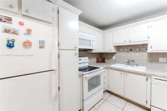 1811 Jefferson St Unit 304, Hollywood, FL 33020 - kitchen with white appliances, decorative backsplash, white cabinetry, and light tile patterned floors