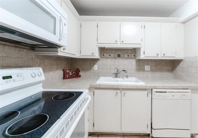 1811 Jefferson St Unit 304, Hollywood, FL 33020 - kitchen with white appliances, white cabinetry, tasteful backsplash, and tile countertops