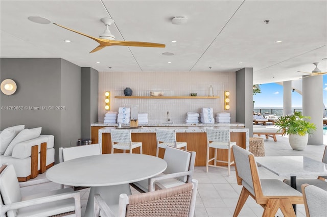 dining room featuring a wall of windows, recessed lighting, light tile patterned floors, and ceiling fan