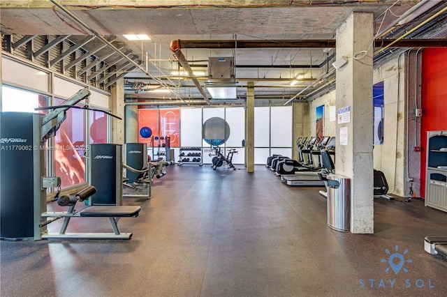 exercise room featuring a high ceiling