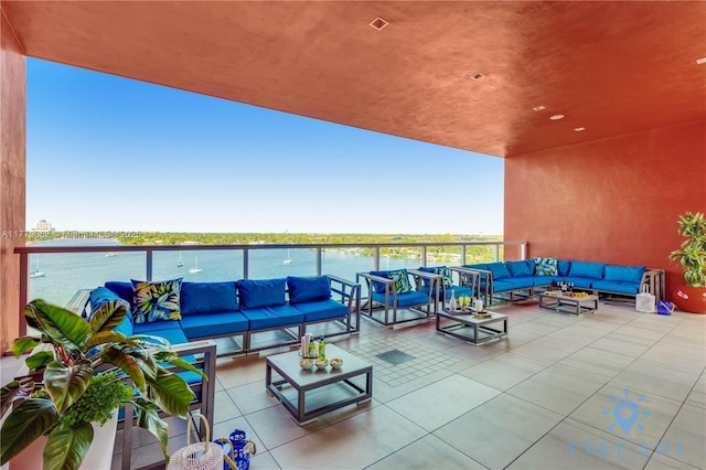 view of patio / terrace with an outdoor living space and a water view