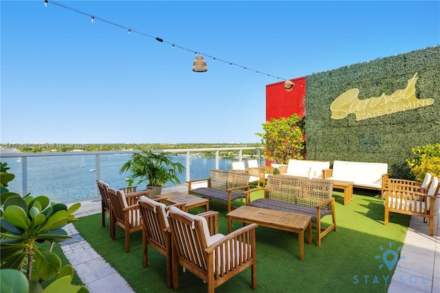 view of patio featuring a water view and outdoor lounge area