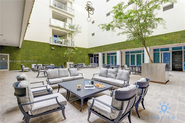 view of patio with outdoor lounge area and visible vents