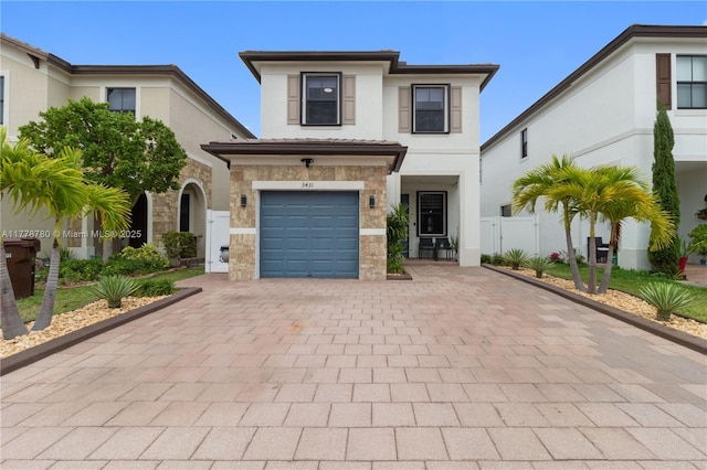 3431 W 109th Pl, Hialeah, FL 33018 - view of front of home featuring decorative driveway, a gate, stucco siding, and stone siding