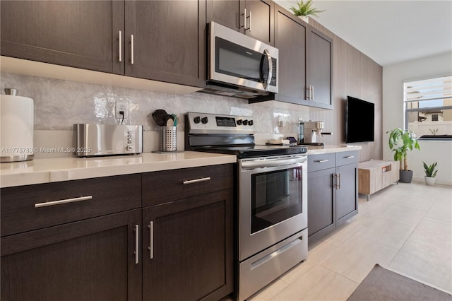 3431 W 109th Pl, Hialeah, FL 33018 - kitchen featuring appliances with stainless steel finishes, light countertops, decorative backsplash, and dark brown cabinets