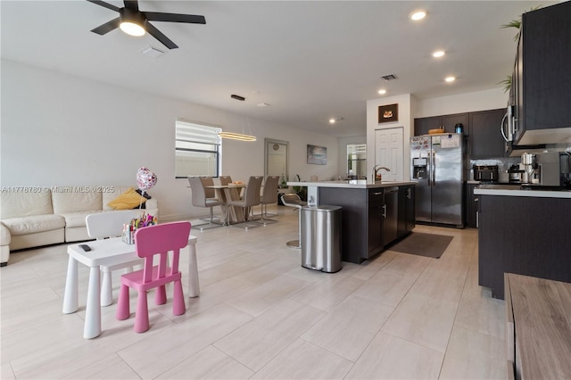 3431 W 109th Pl, Hialeah, FL 33018 - kitchen with stainless steel appliances, a center island with sink, ceiling fan, recessed lighting, and light countertops