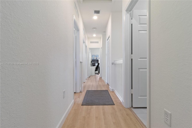 3431 W 109th Pl, Hialeah, FL 33018 - hallway featuring a textured wall, light wood-style floors, and recessed lighting