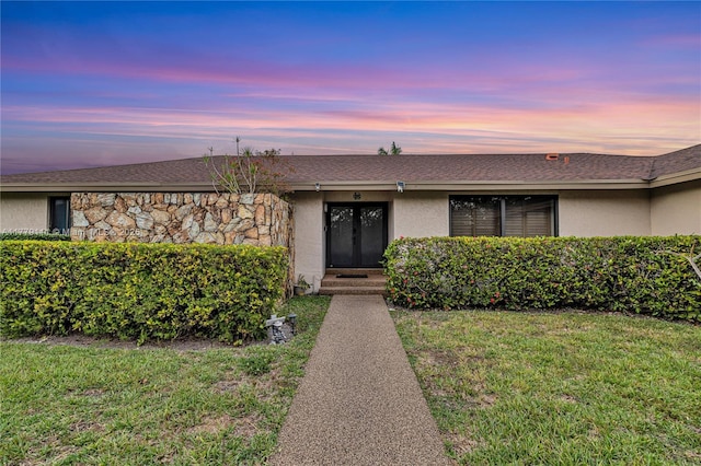 7801 SW 170th St, Palmetto Bay, FL 33157 - single story home featuring roof with shingles, stucco siding, french doors, stone siding, and a lawn