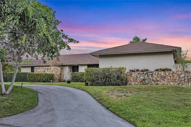 7801 SW 170th St, Palmetto Bay, FL 33157 - ranch-style home with a front yard, roof with shingles, curved driveway, and stucco siding