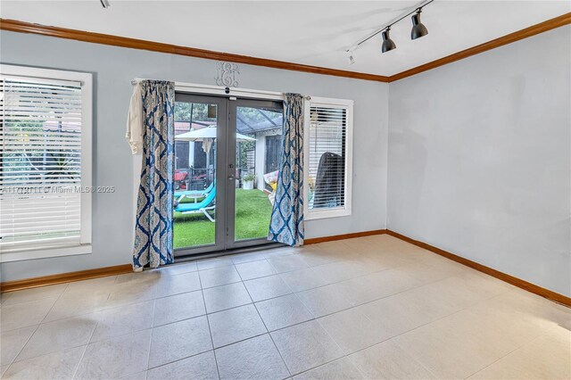 7801 SW 170th St, Palmetto Bay, FL 33157 - spare room featuring crown molding, french doors, baseboards, and rail lighting