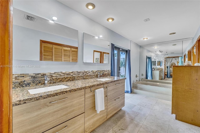 7801 SW 170th St, Palmetto Bay, FL 33157 - bathroom featuring a bath, double vanity, a sink, and visible vents