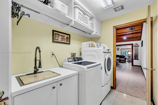 7801 SW 170th St, Palmetto Bay, FL 33157 - laundry room with visible vents, a sink, cabinet space, washing machine and dryer, and light tile patterned flooring