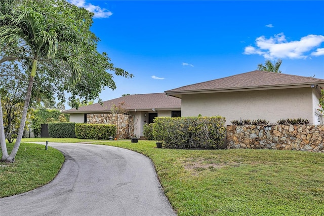 7801 SW 170th St, Palmetto Bay, FL 33157 - ranch-style house with curved driveway, stucco siding, and a front lawn