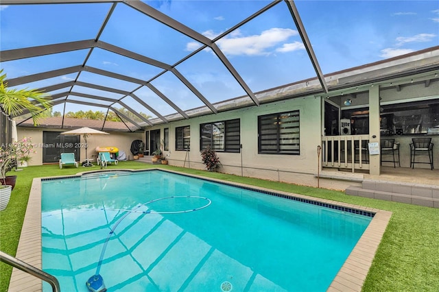 7801 SW 170th St, Palmetto Bay, FL 33157 - outdoor pool featuring a lanai, outdoor dry bar, a patio area, and a lawn