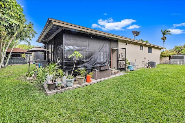 7801 SW 170th St, Palmetto Bay, FL 33157 - rear view of house featuring a gazebo, fence, and a lawn