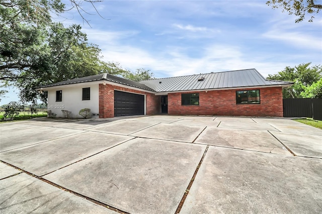 ranch-style home featuring an attached garage, driveway, fence, and brick siding