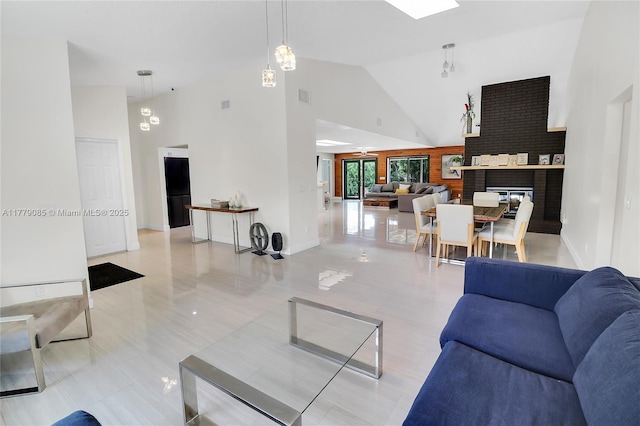 living area featuring visible vents, baseboards, and high vaulted ceiling