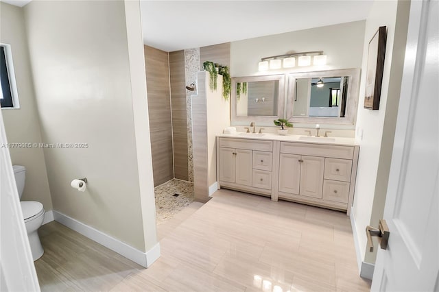 bathroom with a sink, toilet, a walk in shower, and double vanity
