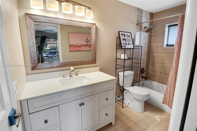 full bath featuring toilet, shower / bath combo, a healthy amount of sunlight, and vanity