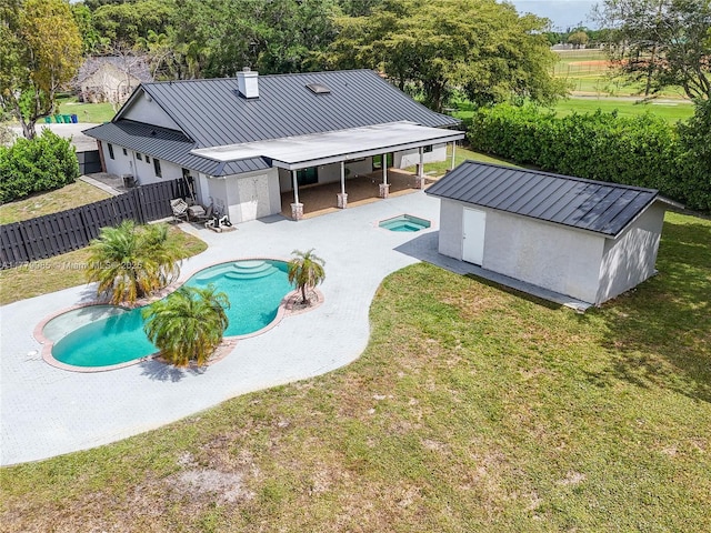 view of pool featuring a fenced in pool, a patio, a fenced backyard, an outbuilding, and a yard