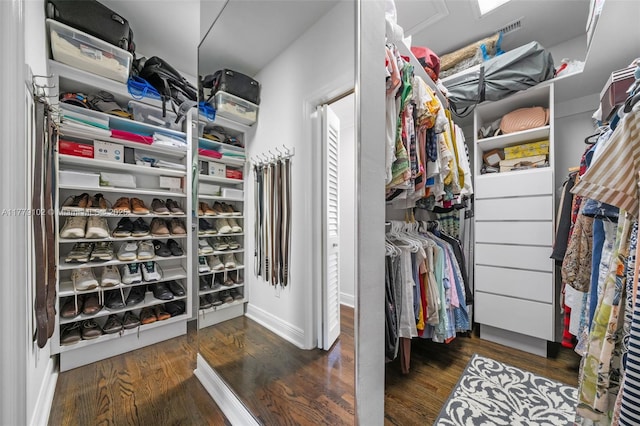 walk in closet with wood finished floors