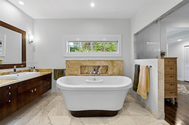 full bathroom with recessed lighting, vanity, marble finish floor, and a soaking tub