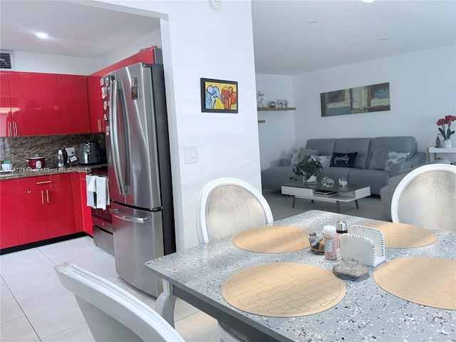 13255 SW 7th Ct Unit 401D, Pembroke Pines, FL 33027 - kitchen with red cabinetry, freestanding refrigerator, range, decorative backsplash, and light tile patterned flooring