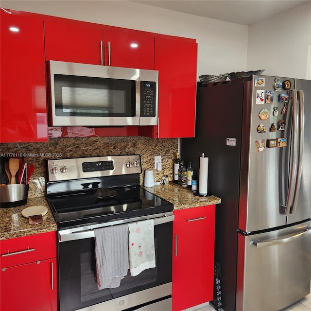 13255 SW 7th Ct Unit 401D, Pembroke Pines, FL 33027 - kitchen with red cabinetry, appliances with stainless steel finishes, and backsplash